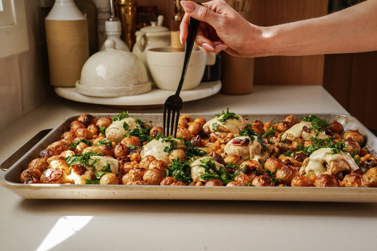 Sheet pan chicken with a fork going into it