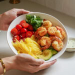 Hands holding shrimp bowl