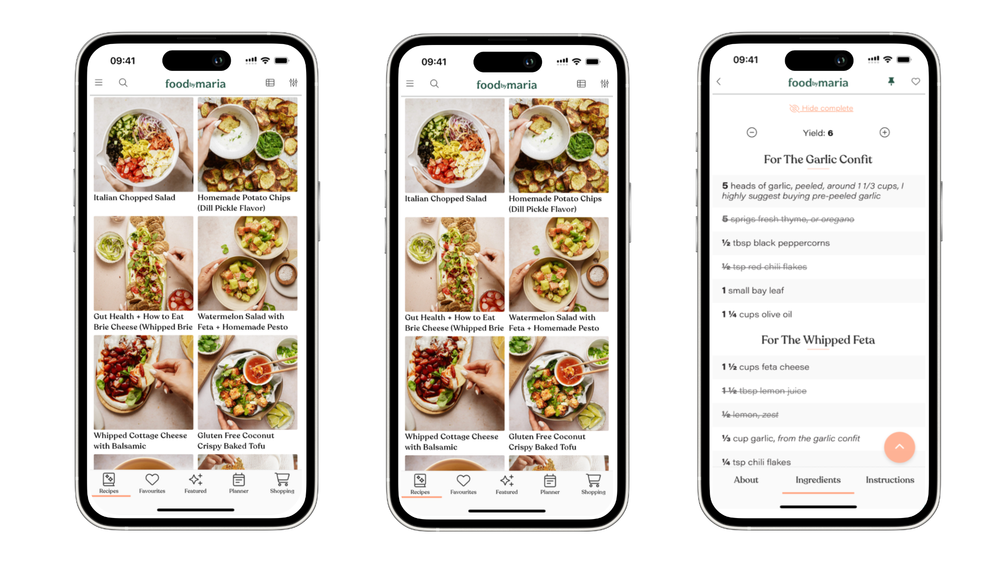 Three smartphones display a recipe app interface called food+maría, showing various recipes with photos, names, and a detailed recipe screen listing ingredients and instructions for garlic confit and whipped feta.
